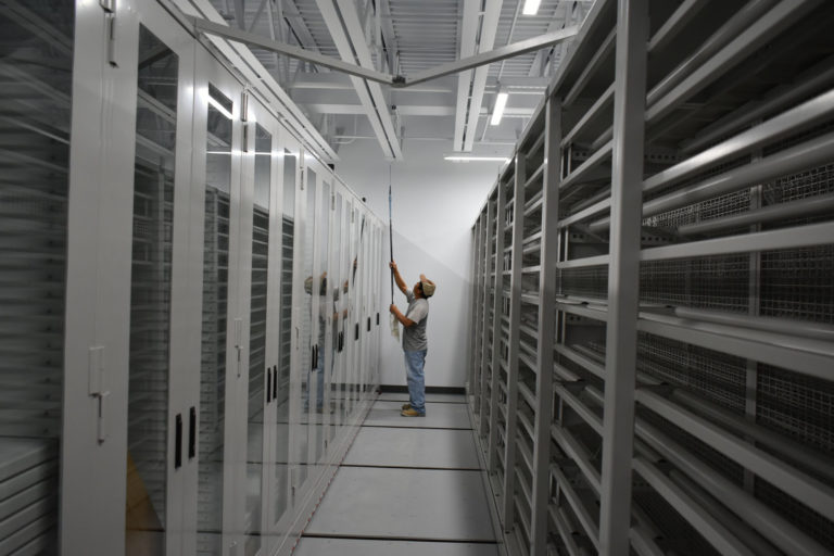 A worker puts the final touches on the new collections storage facility (March 2017).