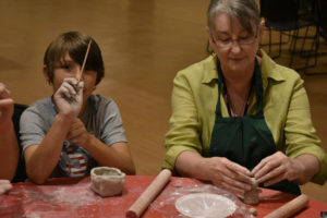 Explorers Camper with teacher creating clay figures