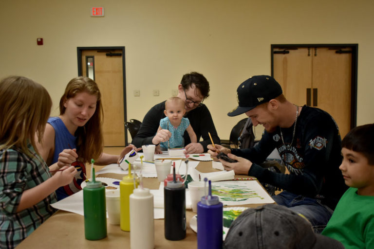 Parents painting with their kids