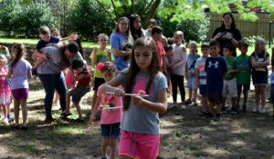 Dino Campers participating in an egg race