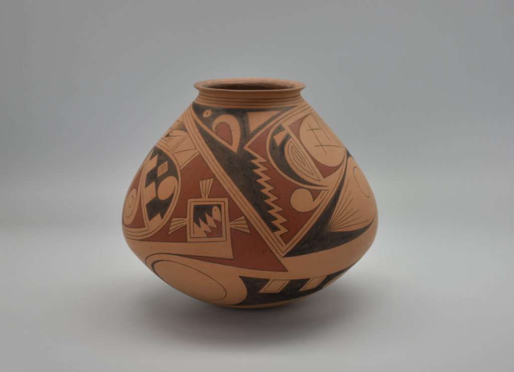 A ceramic jar with abstract geometric designs by Juan Quezada