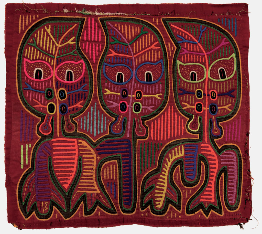 A reverse appliqué cotton cloth panel featuring three spirit figures with leaf-shaped heads