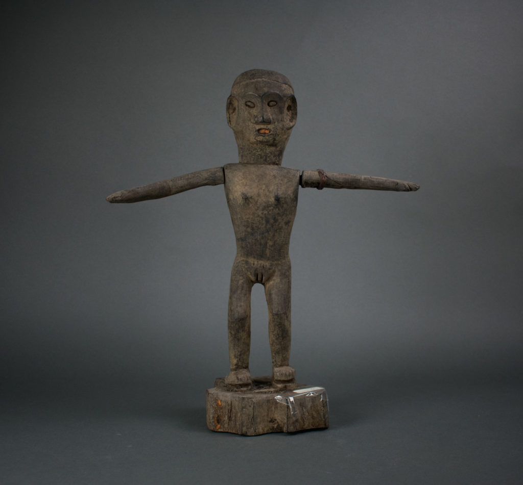 A wooden effigy of an ancestor with its arms outstretched