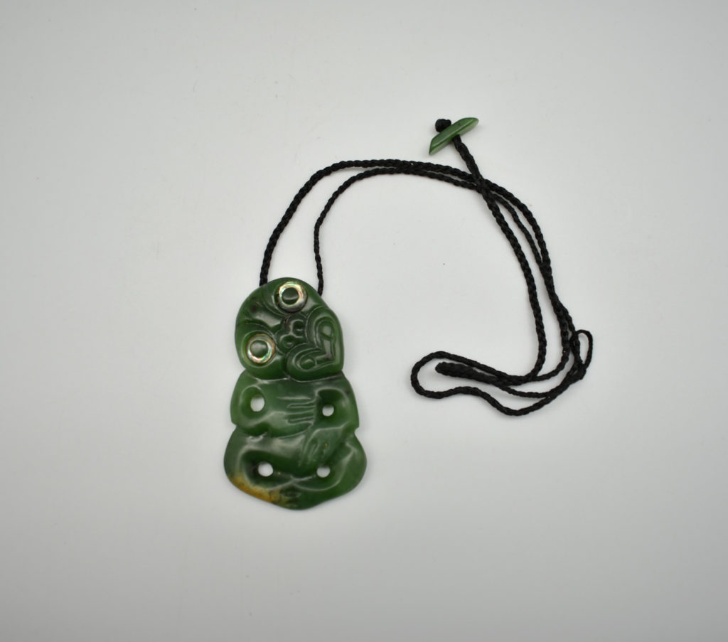 A small jade pendant carved in the shape of a hei-tiki figure (New Zealand)