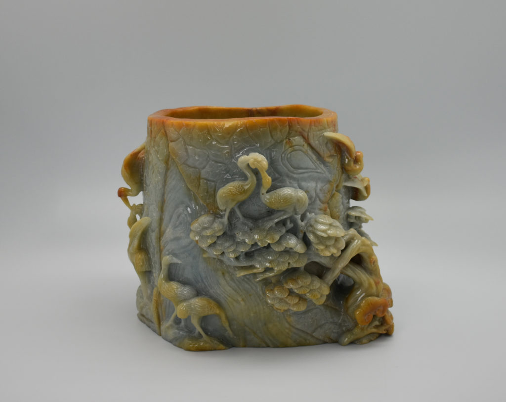 A large jade brush holder decorated with cranes and trees