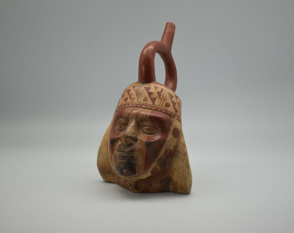A ceramic sculpted in the shape of a warrior's face