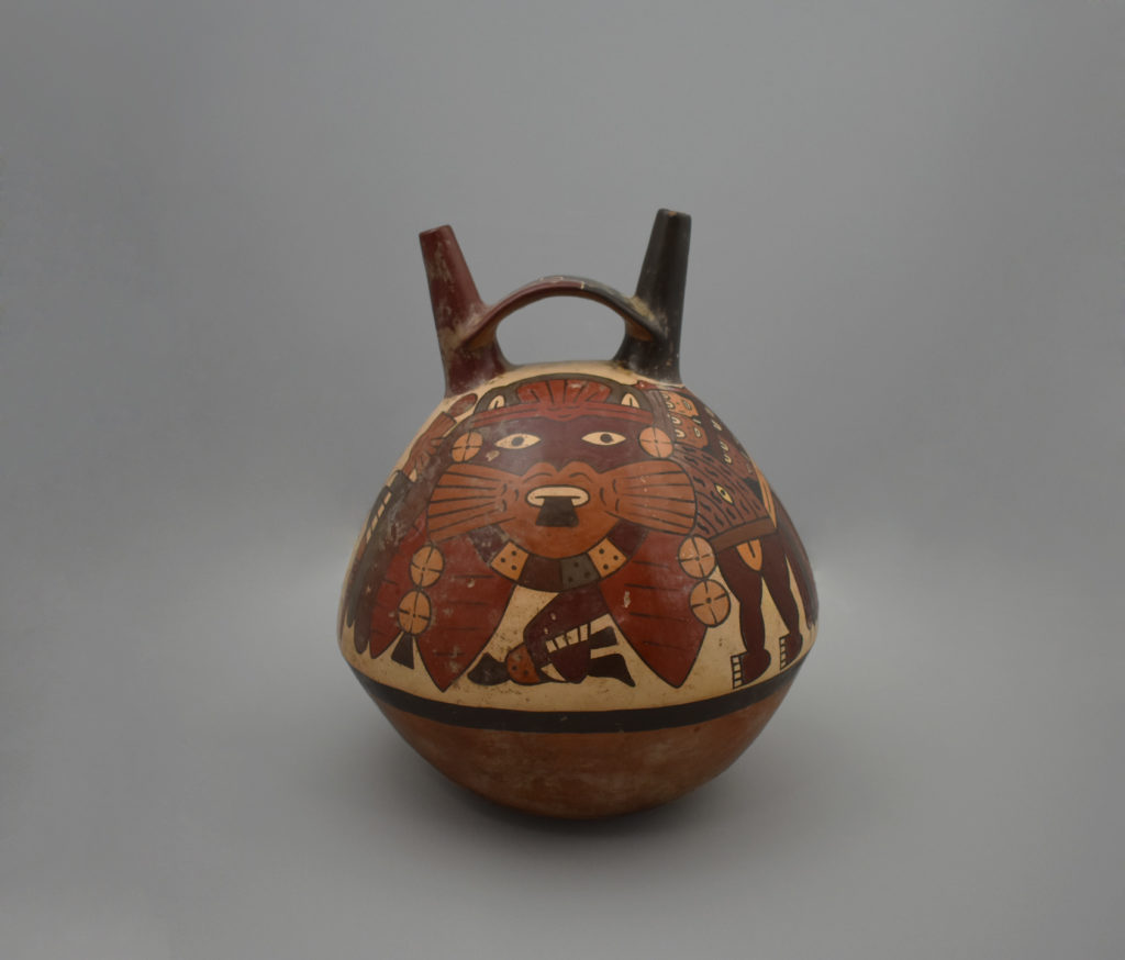 A stirrup spout jar featuring a painted, supernatural, feline-like being