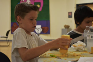 Summer Explorers Camper creating a kachina-style doll.