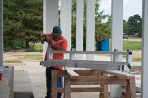 Contractor preparing a glass frame for installation