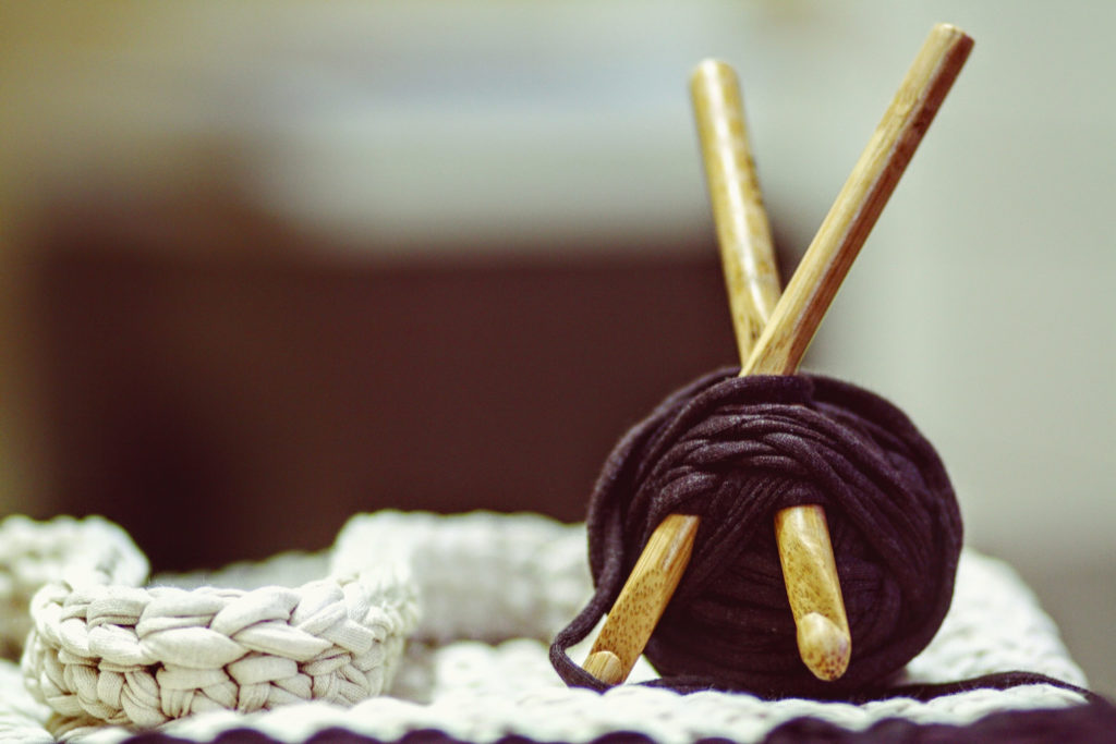 Ball of yarn with knitting needles