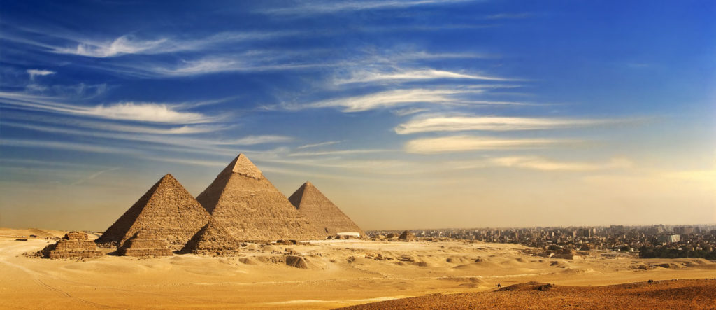 General view of pyramids and cityskape from the Giza Plateau (on front side:)